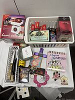 Photo of the boxed Home Cuisine 6.5 lb/3 kg mechanical food scale with various kitchen items in baskets including kitchen knives, magnets, a Maxine comic book, tea packets, and pinch bowls.