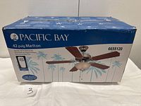 Closed retail box featuring Pacific Bay branding and product details including model MLT42AN5LK1RC, 42-inch size, Marlton series, and remote control included.