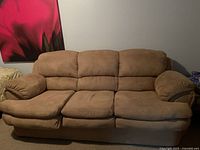 Front view of a large three-seat brown suede sofa with plush cushions and padded armrests.