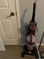 Upright Powerforce Turbo vacuum cleaner with upright handle, clear dust container tank, rotary dial base, and cord wrapped on back.