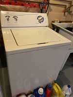 Front and side view of white Inglis top load washing machine