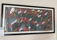 Full front view of framed artwork laid flat against wall