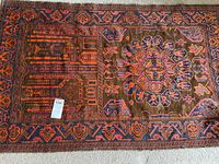 Full view of rug showing central medallion and mosque motifs