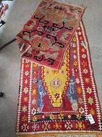 Two rugs laid out on floor, overview of lot