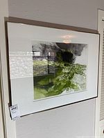 Framed etching print hung on wall, showing overall artwork and frame.