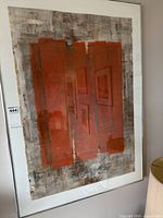 Full view of framed oil painting on paper leaning against wall