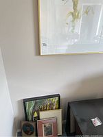 Framed abstract mixed media artwork by Sylvia Bews-Wright leaning against wall