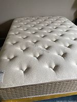 Top view of the mattress showing tufted surface and Organic Cotton branding.