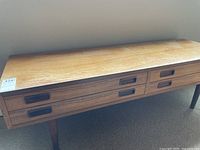 Front view showing full table length, two drawers with recessed handles, and four legs