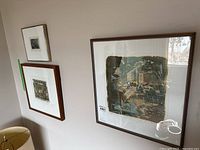 Framed print 'The Café' by Ewan Cameron hanging on wall