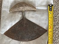 Top view showing the full ulu cutter with curved rusted iron blade and bone handle alongside a tape measure indicating blade width around 12 cm.