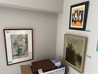 Overview of three framed artworks against a light wall