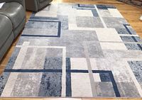 Full view of the contemporary area rug showing geometric pattern and colors.
