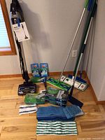Shark DuoClean vacuum upright with mop handles and cleaning cloths arranged on floor