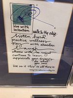 Framed inspirational art featuring motivational sayings handwritten with a small green watercolor block, titled 'live with intention' by Maryanne Radmachos-Hershey.