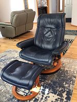 Front view of navy blue leather chair with footstool