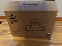 Original cardboard box of Bissell Little Green portable deep cleaner model 1400B with printed product image and brand.