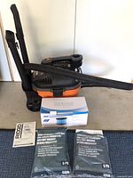 Full view of Ridgid 4 gallon shop vac with hose attached, box with Reinlichkeit filter, two 5-pack packages of Powertec high efficiency filter bags, and instruction manual.