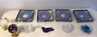Full array of items: 4 Wedgewood blue decorative plates in original boxes, along with 5 glass decor items including two globes and bird figurines.