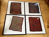 All four framed textile panels laid out on floor