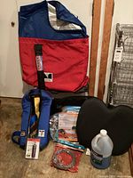 Full view of all items including red bag, life vest, tow cable, seat cushion, washer fluid