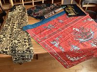 Overview of four textiles laid out on wooden table