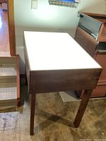 Front view of light table illuminated, showing wooden frame and glowing top