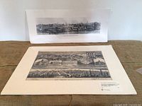 Two prints displayed on cloth: front multiview lithograph, back panoramic photo
