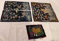 All five embroidery pieces plus blue backing arranged flat