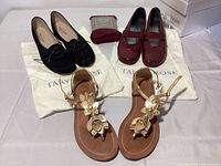 Full lot laid out showing the two pairs of Taryn Rose shoes, Coach metallic floral sandals, and packaged Nordstrom tights