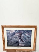 Full view of framed art print "Evening Walk" with wooden frame showing minor wear