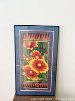 Front view of framed art print with red and yellow flowers and geometric border