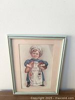 Full view of framed art print showing child holding bread loaves with 'USE YEAST FOAM' apron text.