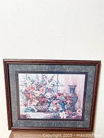 Full view of the framed floral still life picture including vases and fruit.