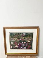 Full view of framed floral garden print with ornate gold frame