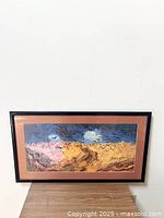 Framed print on a wooden surface, showing entire artwork and frame