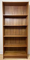 Straight-on frontal view of the teak bookshelf