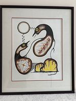 Front view of framed James Kakepetum 1983 limited edition print with visible signature and detailed artwork showing Indigenous stylized birds and patterns.