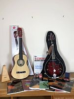 Overview of mandolin, guitar, metronome, books on table