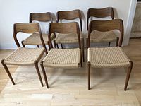 Six chairs arranged in two rows showing overall set and missing leg on front center chair