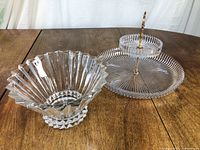 Wide view of Rosenthal serving bowl and two-tiered server on wooden table.