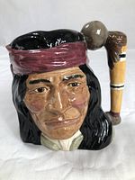 Front view of the Geronimo Toby jug showing detailed facial features and red headband.