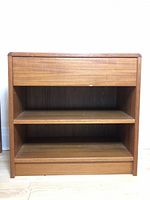 Front view of teak side table showing drawer and two shelves