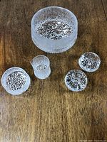 Full set of Ultimate Thule bowl, two candle stick holders, sugar and creamer displayed on wood surface.