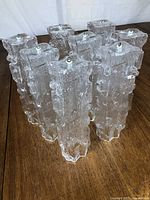 Eight textured clear glass tubes arranged in a circular formation showing the chandelier's overall structure.