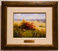 Framed oil painting showing bright autumn colors and metal plaque with artist name.