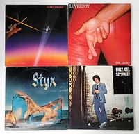 Four vinyl record albums by Supertramp, Loverboy, Styx, Billy Joel displayed together to show all covers.