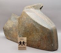 Front-right three-quarter view showing full form with scale card