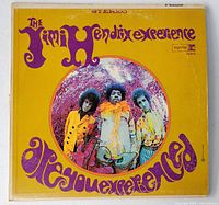 Front cover of the Jimi Hendrix LP titled "Are You Experienced" with yellow background and purple lettering. Center image shows the band members in colorful outfits.