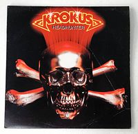 Front cover of the vinyl LP album jacket showing the metallic skull and crossed bones logo with the Krokus band name and 'Headhunter' title.
